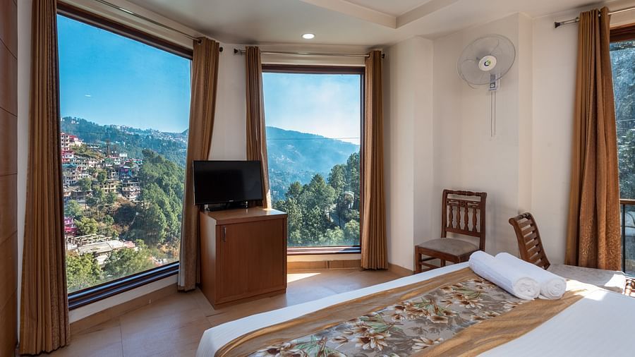 Executive Room 3D with front-facing jungle view, showcasing nature through a large glass window at DLS Hotels The Rock Castle.